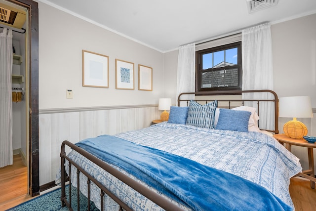 22 Wixon Rd, Dennis Port, MA 02639 - bedroom with wood finished floors, crown molding, and wainscoting