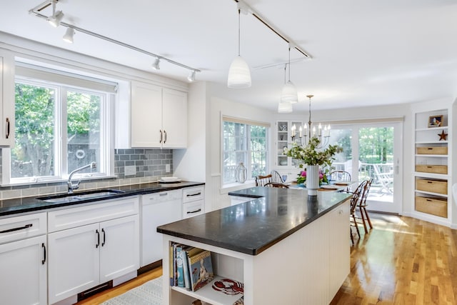 20 Hoyt Rd, Eastham, MA 02642 - kitchen featuring a sink, rail lighting, dishwasher, open shelves, and white cabinetry