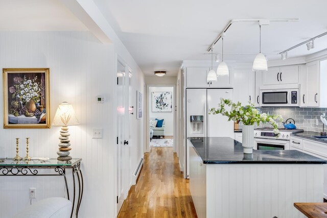 20 Hoyt Rd, Eastham, MA 02642 - kitchen with white appliances, light wood-style flooring, track lighting, and white cabinets