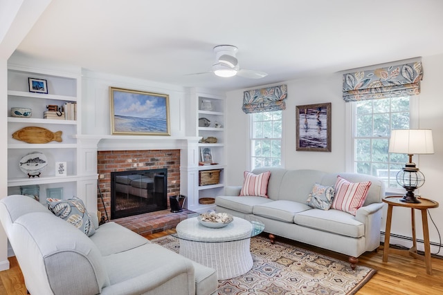 20 Hoyt Rd, Eastham, MA 02642 - living area featuring wood finished floors, ceiling fan, built in shelves, and a fireplace