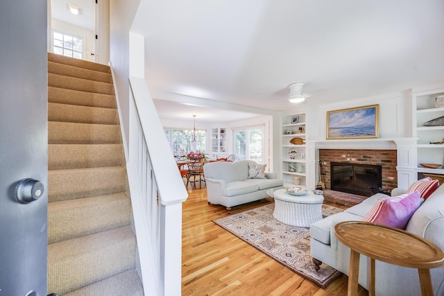 20 Hoyt Rd, Eastham, MA 02642 - living room with wood finished floors, stairway, healthy amount of natural light, and a fireplace