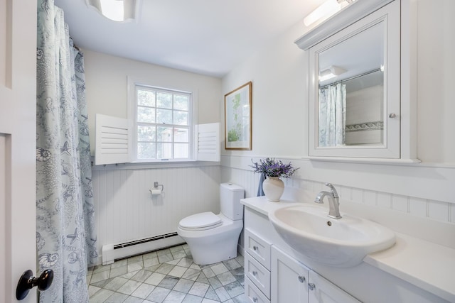 20 Hoyt Rd, Eastham, MA 02642 - full bathroom with a baseboard radiator, wainscoting, vanity, toilet, and tile patterned floors