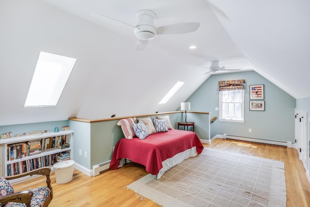 20 Hoyt Rd, Eastham, MA 02642 - bedroom with a baseboard radiator, a skylight, wood finished floors, and vaulted ceiling