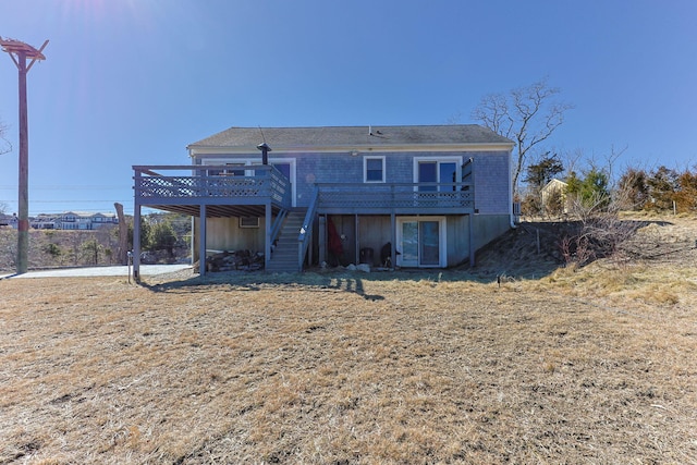 rear view of house featuring stairway and a wooden deck