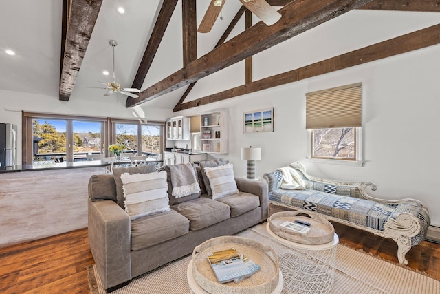 living area featuring ceiling fan, high vaulted ceiling, wood finished floors, and beamed ceiling