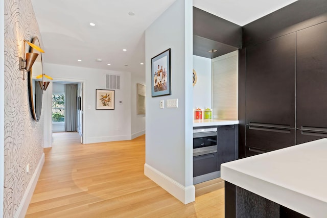 hallway with light hardwood / wood-style floors