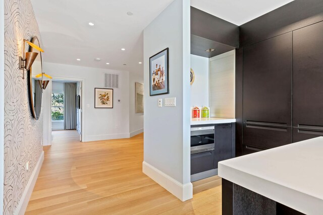 hallway with light hardwood / wood-style floors