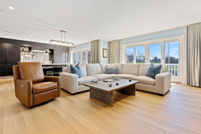 living room with french doors and light hardwood / wood-style flooring