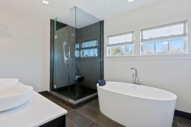 bathroom with vanity, tile patterned floors, plenty of natural light, and plus walk in shower