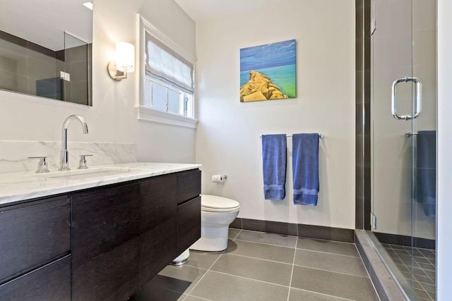 bathroom with an enclosed shower, tile patterned floors, vanity, and toilet