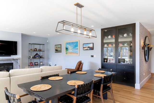 dining space with light hardwood / wood-style flooring