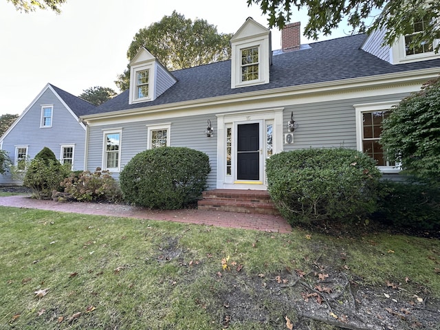 new england style home with a front yard