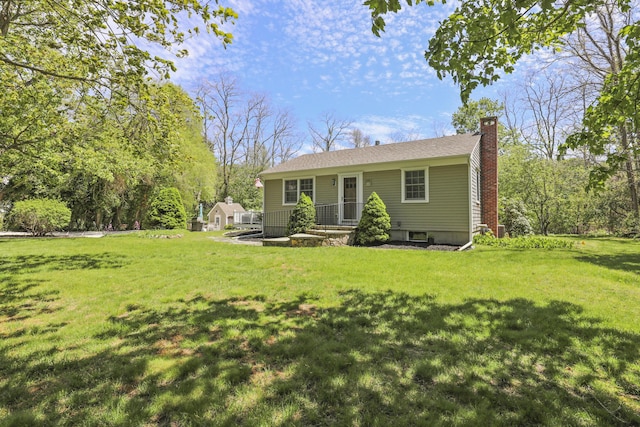 33 Beach Rd, Orleans, MA 02653 - view of front of home with a chimney and a front lawn