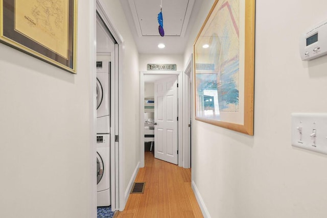 33 Beach Rd, Orleans, MA 02653 - hall with attic access, stacked washer and clothes dryer, baseboards, light wood finished floors, and recessed lighting