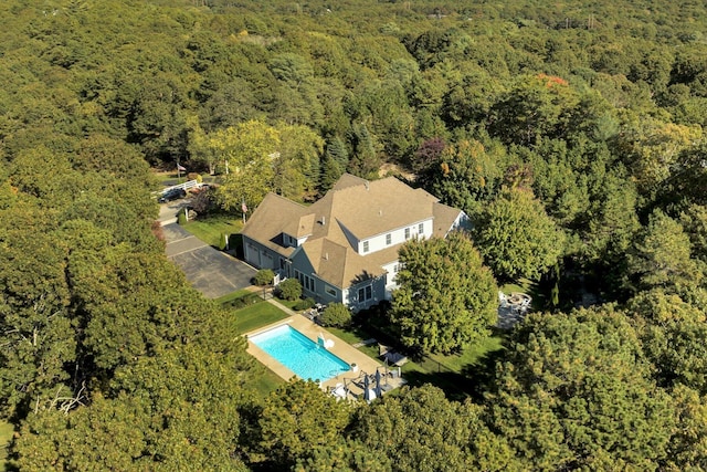 drone / aerial view featuring a forest view
