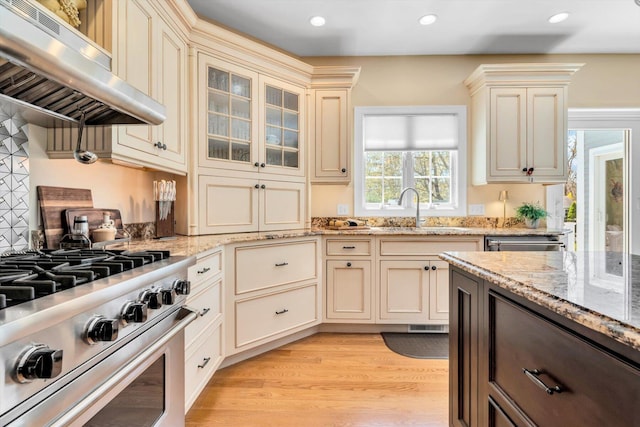 kitchen featuring a sink, stainless steel appliances, recessed lighting, cream cabinetry, and under cabinet range hood