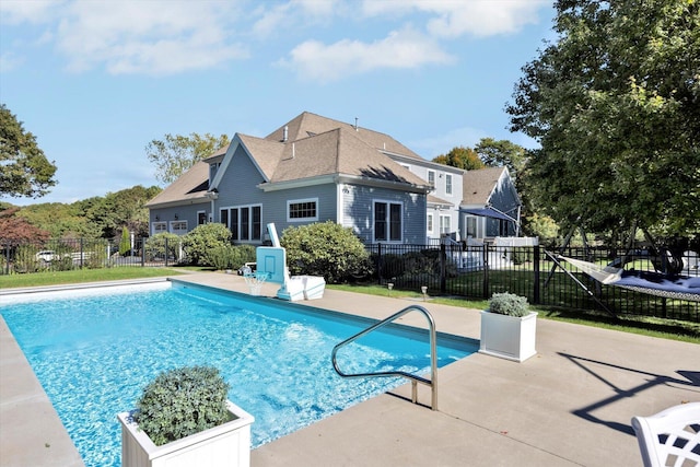 view of pool with a fenced in pool, fence, and a patio area