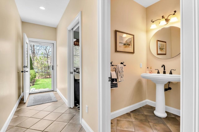 bathroom with baseboards, recessed lighting, and tile patterned floors