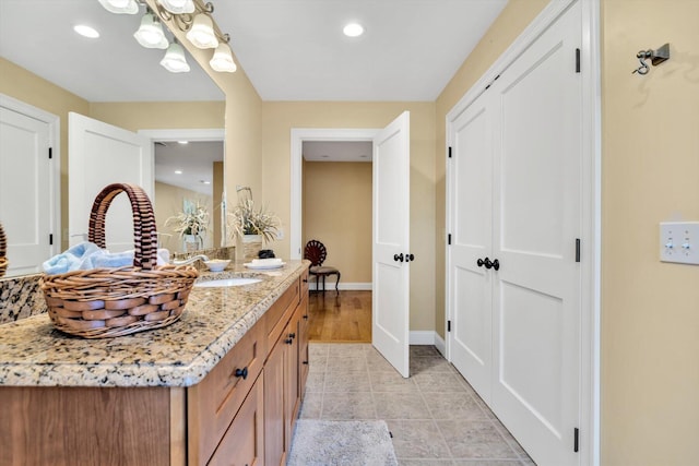 bathroom featuring vanity, recessed lighting, baseboards, and tile patterned floors