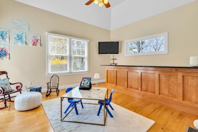 living area with a healthy amount of sunlight, ceiling fan, and light wood finished floors