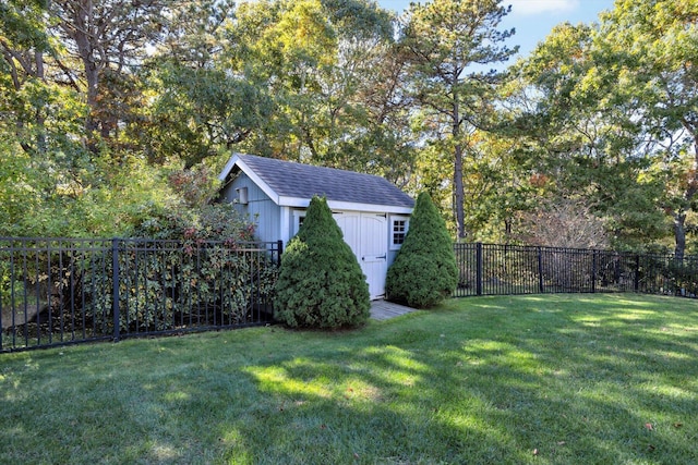 view of yard featuring a fenced backyard, an outbuilding, and a storage shed