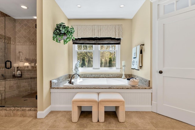 bathroom with baseboards, recessed lighting, tile patterned floors, a bath, and a shower stall