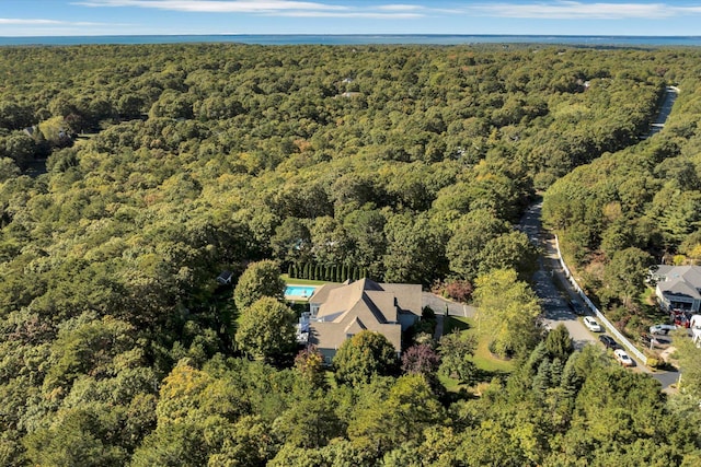 birds eye view of property featuring a view of trees