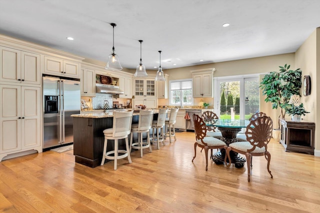 kitchen featuring a kitchen island, stainless steel appliances, recessed lighting, and light wood-style flooring
