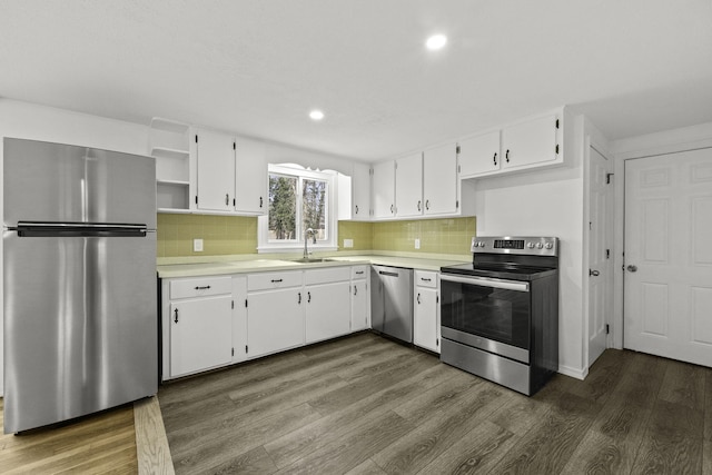 kitchen featuring sink, white cabinets, appliances with stainless steel finishes, and decorative backsplash