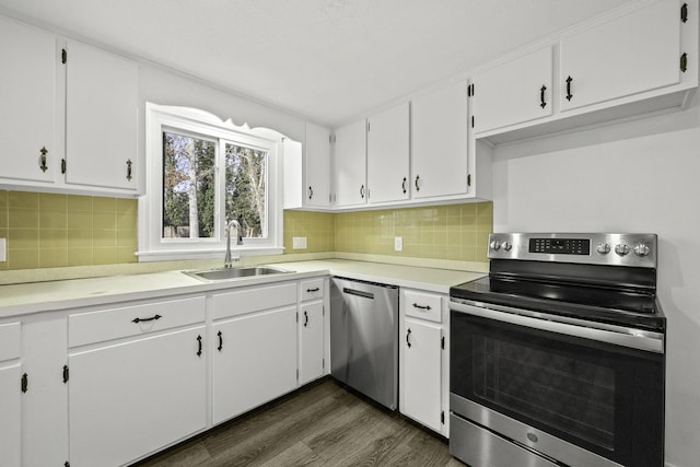 kitchen with sink, stainless steel appliances, white cabinets, and dark hardwood / wood-style flooring