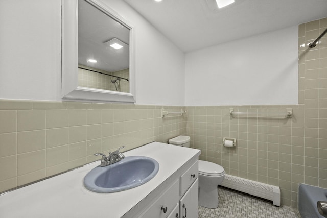 bathroom with vanity, tile walls, baseboard heating, and tile patterned flooring