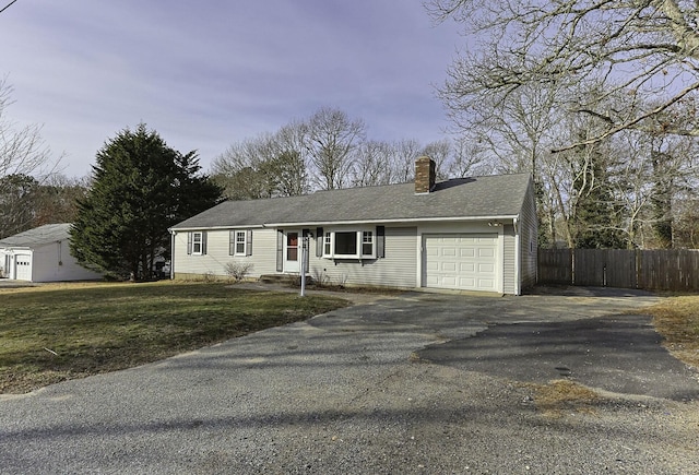 ranch-style home with a front yard and a garage