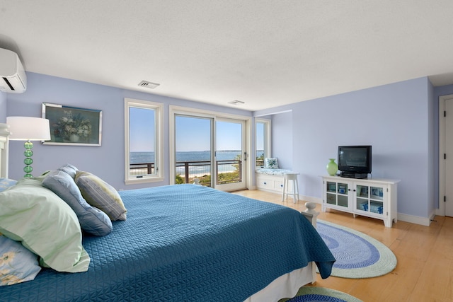 142 Greely Ave, Centerville, MA 02632 - bedroom featuring a wall mounted air conditioner, access to exterior, and light wood-style floors