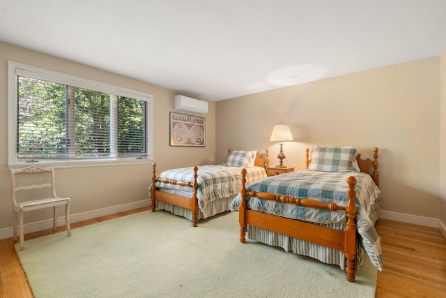 142 Greely Ave, Centerville, MA 02632 - bedroom featuring an AC wall unit and wood finished floors
