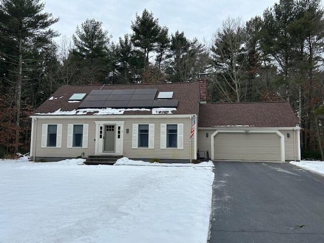 view of front of home with a garage and solar panels