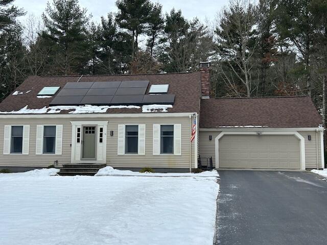 view of front of home with a garage and solar panels