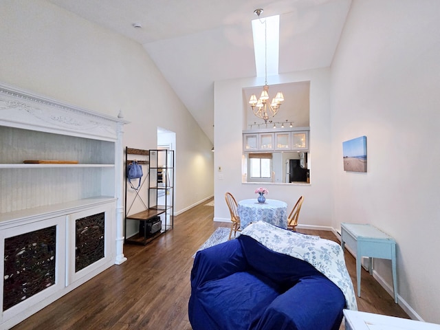 living room with a chandelier, wood finished floors, baseboards, and vaulted ceiling
