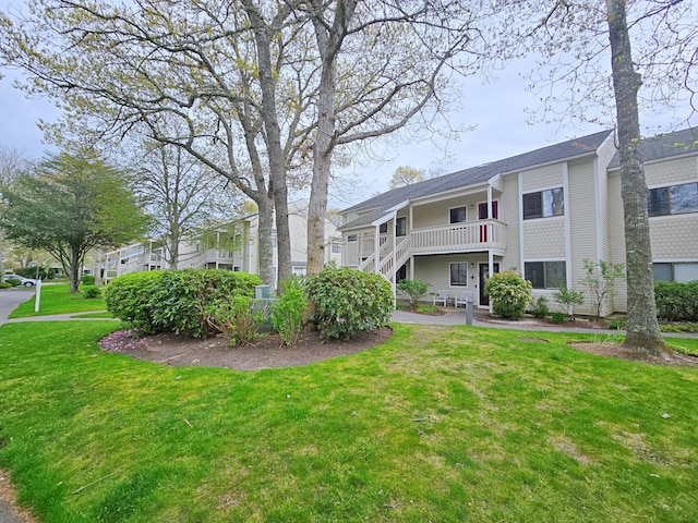 surrounding community featuring a lawn and stairs