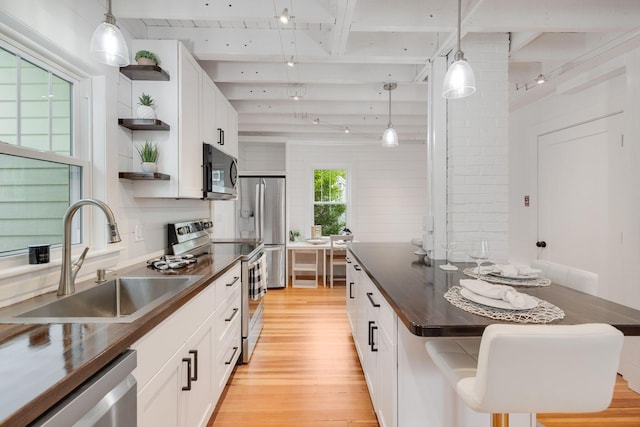12 Dartmouth St, Hyannis, MA 02601 - kitchen with dark countertops, open shelves, a sink, appliances with stainless steel finishes, and beamed ceiling