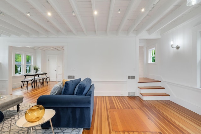 12 Dartmouth St, Hyannis, MA 02601 - living room with rail lighting, light wood-style floors, a decorative wall, plenty of natural light, and beam ceiling