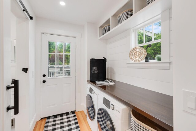12 Dartmouth St, Hyannis, MA 02601 - laundry area with plenty of natural light, washer and clothes dryer, light wood-style flooring, a barn door, and recessed lighting