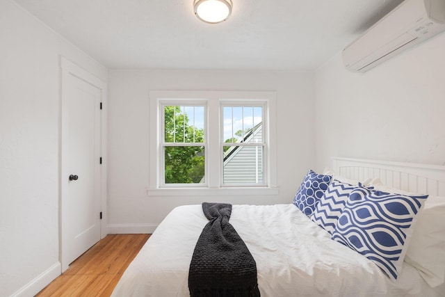 12 Dartmouth St, Hyannis, MA 02601 - bedroom with a wall mounted AC, wood finished floors, and baseboards