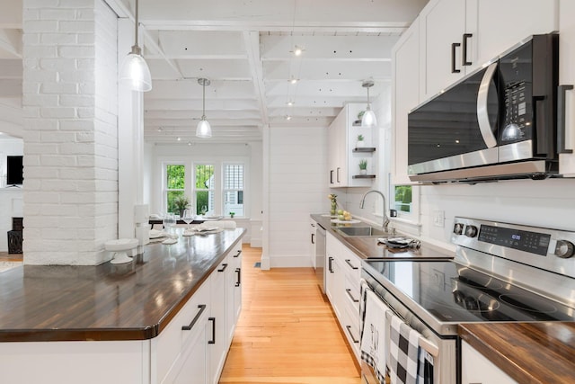 12 Dartmouth St, Hyannis, MA 02601 - kitchen with appliances with stainless steel finishes, wooden counters, a sink, light wood-style floors, and beam ceiling