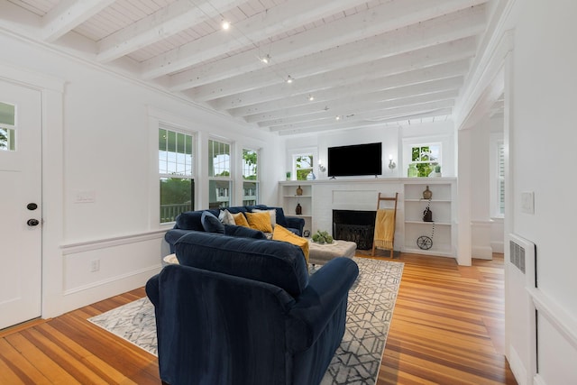 12 Dartmouth St, Hyannis, MA 02601 - living area with a brick fireplace, light wood finished floors, and wooden ceiling with exposed beams