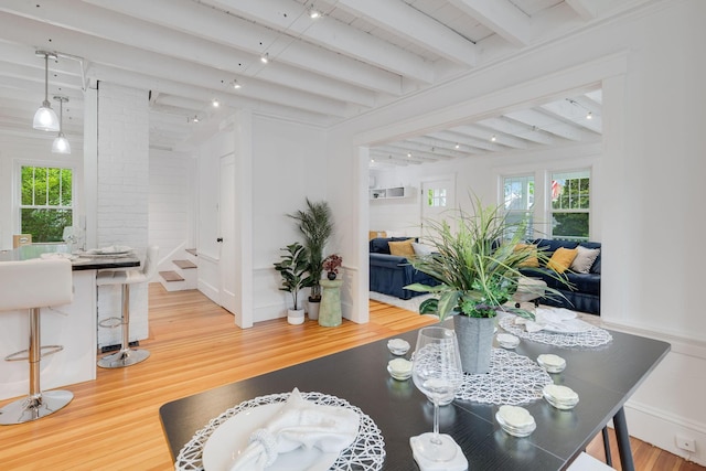 12 Dartmouth St, Hyannis, MA 02601 - dining area featuring beam ceiling, wood finished floors, rail lighting, and decorative columns