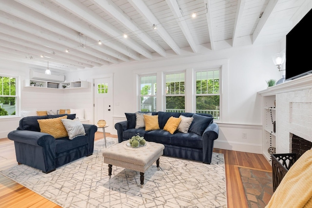 12 Dartmouth St, Hyannis, MA 02601 - living room with a brick fireplace, light wood-style flooring, plenty of natural light, track lighting, and a wainscoted wall