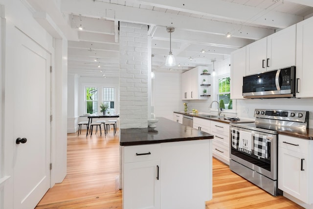12 Dartmouth St, Hyannis, MA 02601 - kitchen featuring stainless steel appliances, dark countertops, light wood finished floors, and beam ceiling