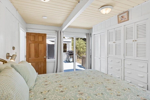 bedroom with wooden ceiling, access to exterior, and beam ceiling