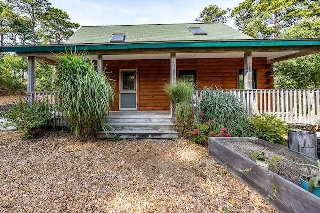 view of front of house featuring covered porch and a vegetable garden