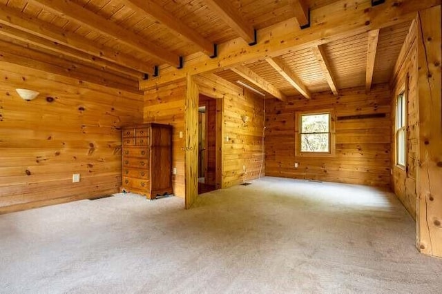 bonus room with wood walls, carpet flooring, and beamed ceiling